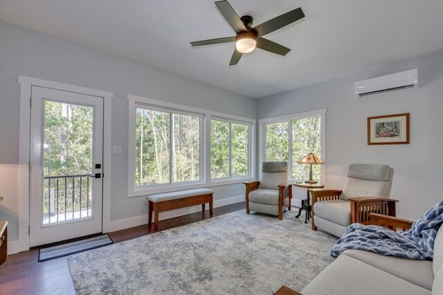 living room with ceiling fan, dark wood-type flooring, and a wall mounted AC