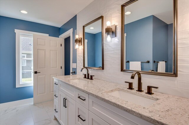 bathroom featuring vanity and backsplash