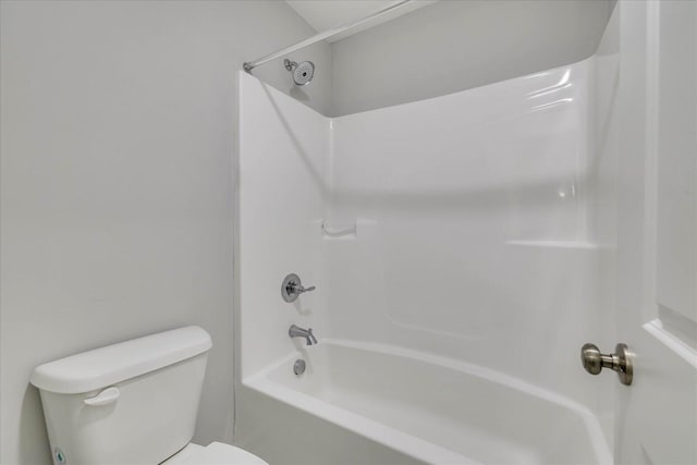 bathroom with shower / washtub combination and toilet