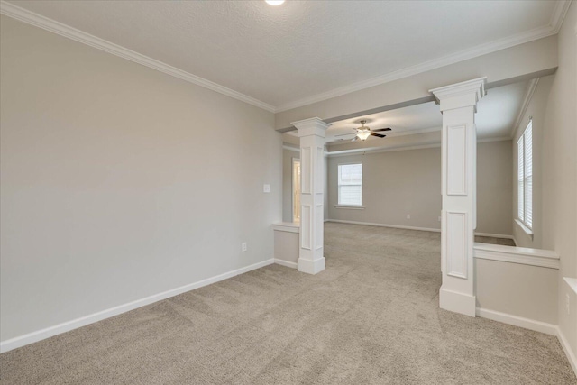 empty room with ornate columns, ornamental molding, and light carpet