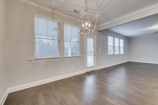 empty room featuring hardwood / wood-style floors, crown molding, and a chandelier