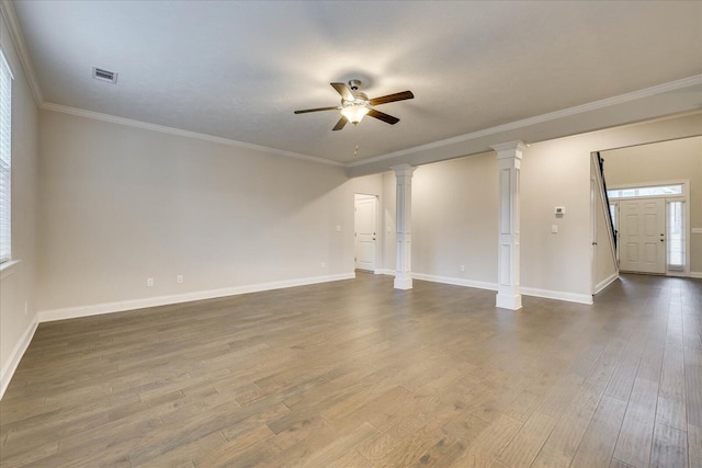 empty room with crown molding, wood-type flooring, decorative columns, and ceiling fan