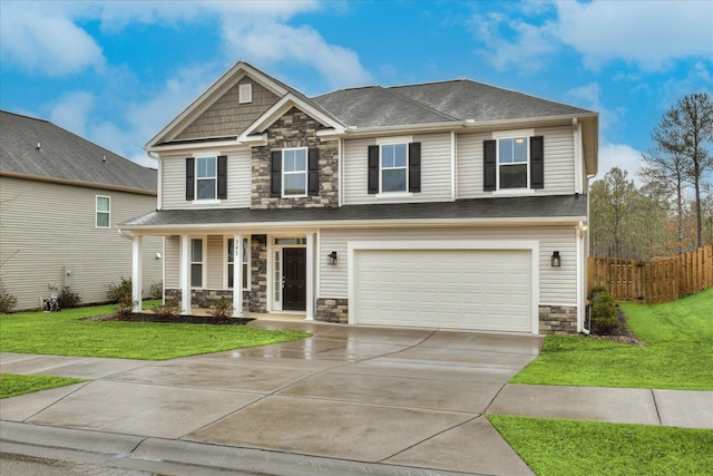 craftsman-style home featuring a garage, covered porch, and a front lawn