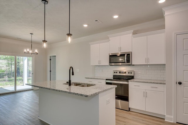 kitchen featuring white cabinets, an island with sink, and appliances with stainless steel finishes