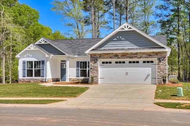 craftsman inspired home featuring a front yard and a garage