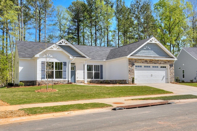 craftsman-style home featuring a garage and a front lawn