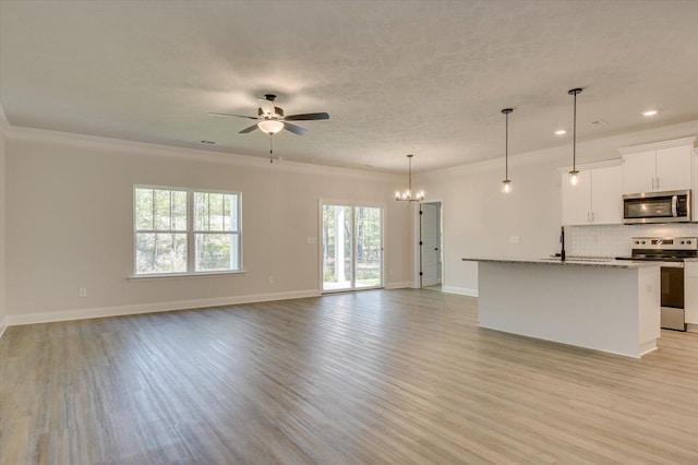 unfurnished living room with a textured ceiling, crown molding, ceiling fan with notable chandelier, and light wood-type flooring