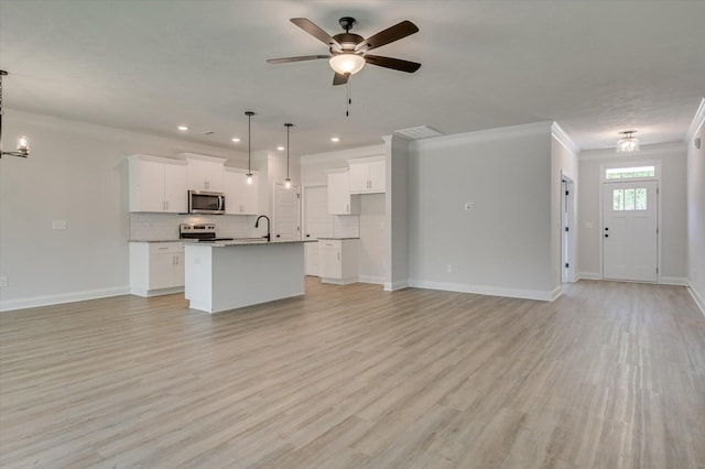 unfurnished living room featuring ceiling fan with notable chandelier, light hardwood / wood-style floors, ornamental molding, and sink