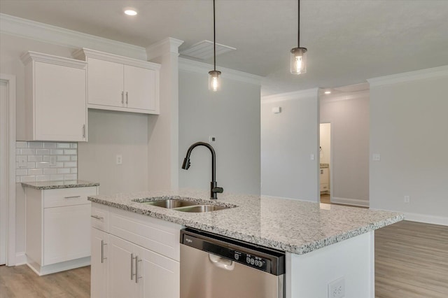 kitchen featuring white cabinets, sink, decorative light fixtures, dishwasher, and an island with sink