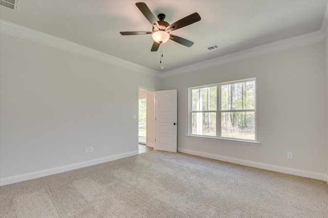 carpeted empty room with ceiling fan and ornamental molding