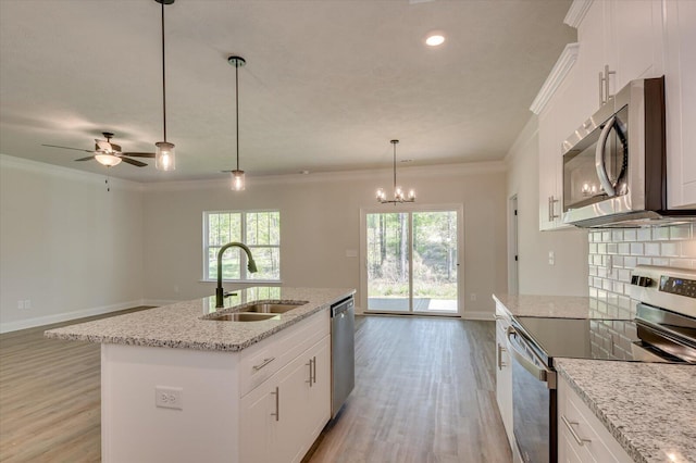 kitchen featuring white cabinets, plenty of natural light, a kitchen island with sink, and appliances with stainless steel finishes