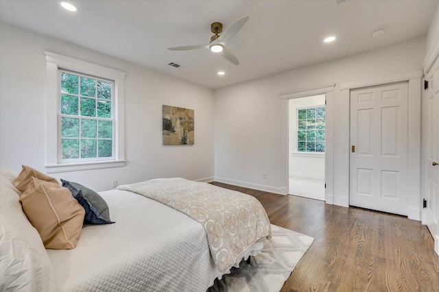 bedroom with ceiling fan and dark hardwood / wood-style floors