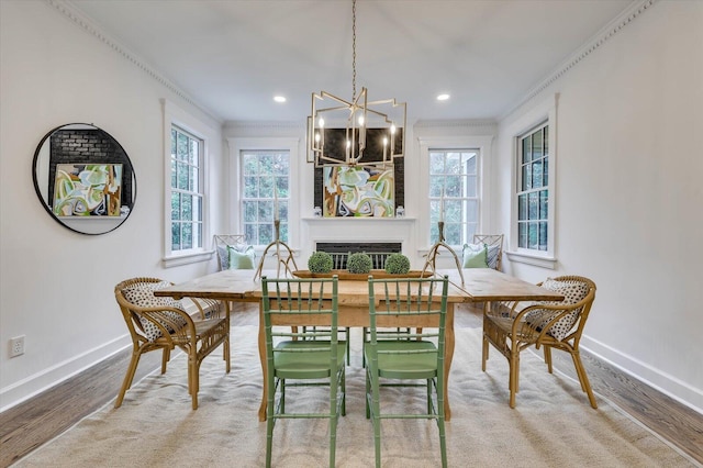 dining space with hardwood / wood-style floors, a wealth of natural light, and crown molding