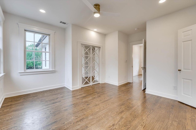 empty room featuring hardwood / wood-style floors and ceiling fan