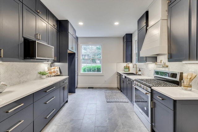 kitchen with tasteful backsplash, stainless steel appliances, premium range hood, and sink