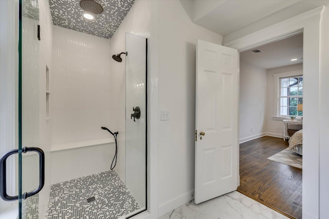 bathroom featuring wood-type flooring and an enclosed shower