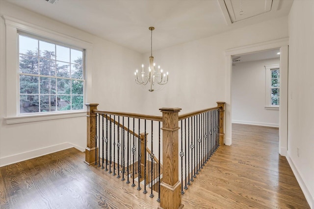 hall featuring hardwood / wood-style flooring and a notable chandelier