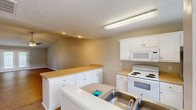 1235 Longpoint Dr, Augusta, GA 30906 - kitchen featuring visible vents, white cabinetry, a peninsula, white appliances, and wood finished floors