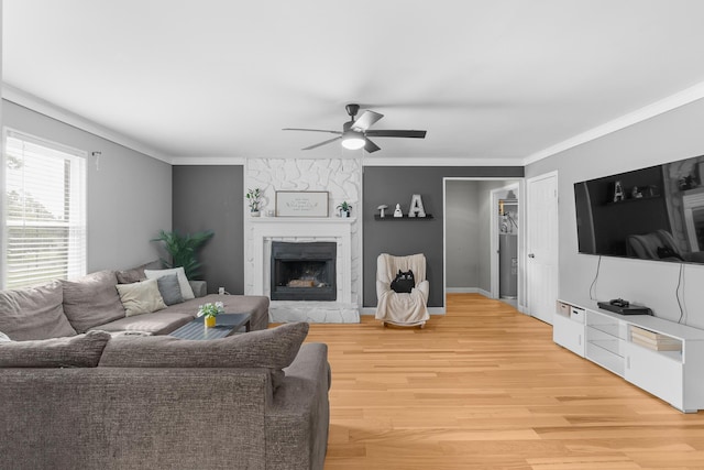 3973 Concord Pl, Martinez, GA 30907 - living room with ceiling fan, a stone fireplace, light wood-type flooring, and crown molding