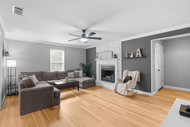 3973 Concord Pl, Martinez, GA 30907 - living room featuring ceiling fan, a fireplace, light wood-type flooring, and crown molding
