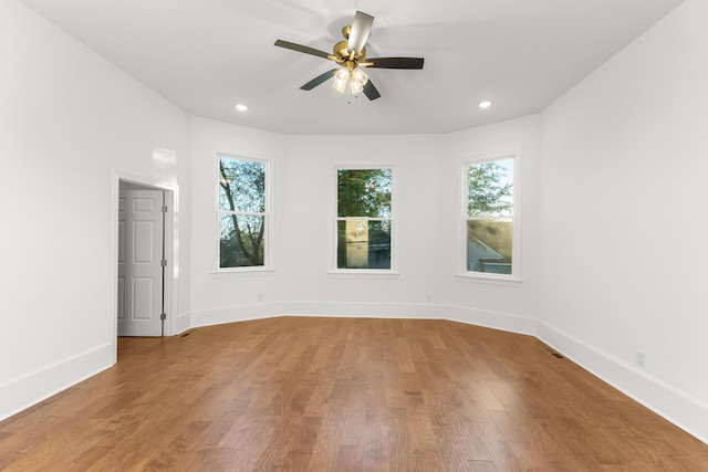 spare room featuring ceiling fan, plenty of natural light, and wood-type flooring