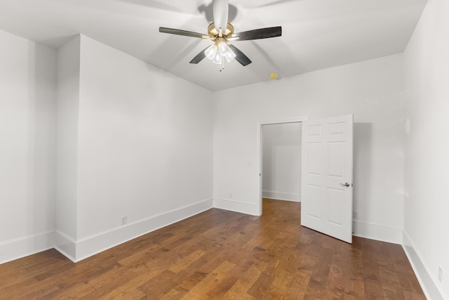 unfurnished room featuring ceiling fan and dark wood-type flooring