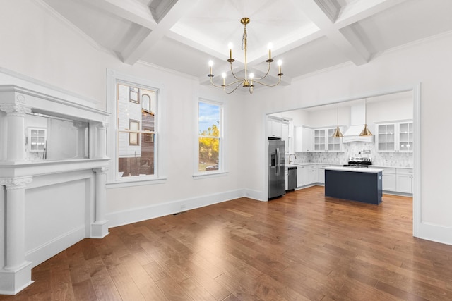 unfurnished living room featuring beamed ceiling, coffered ceiling, and an inviting chandelier