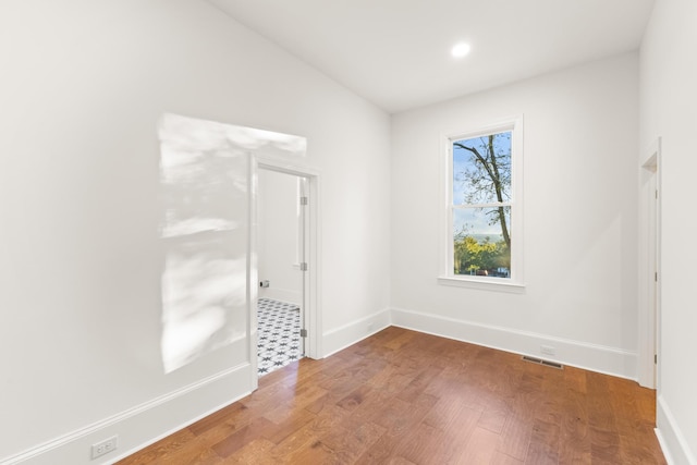 spare room featuring hardwood / wood-style floors