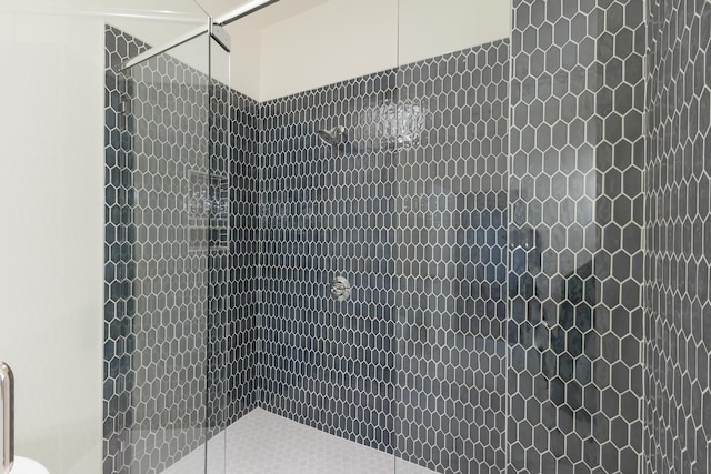 bathroom with a tile shower