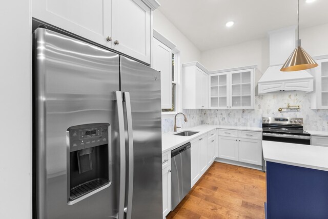 kitchen featuring tasteful backsplash, white cabinetry, sink, and appliances with stainless steel finishes