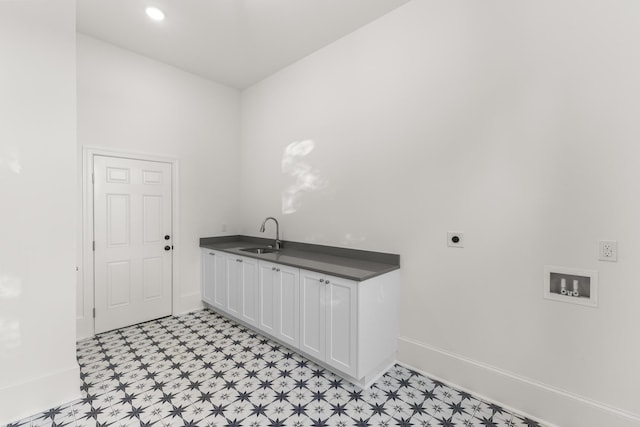 washroom featuring washer hookup, electric dryer hookup, cabinets, and sink