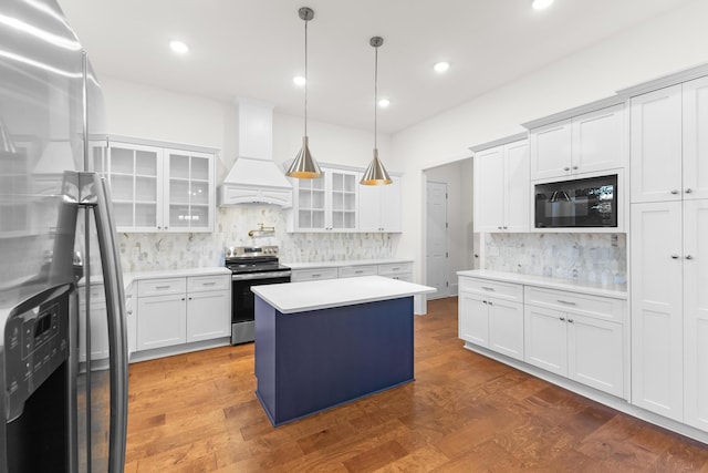 kitchen with white cabinetry, a center island, dark wood-type flooring, stainless steel appliances, and custom exhaust hood