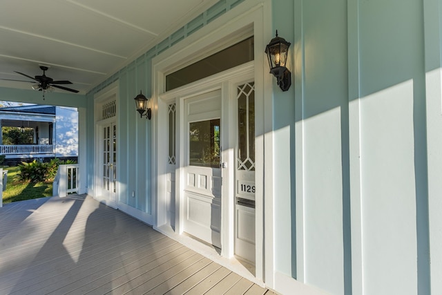 wooden deck with ceiling fan and a porch