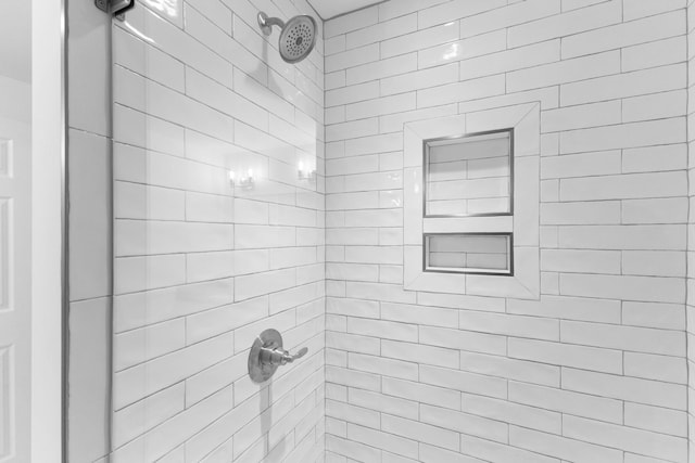 bathroom with a tile shower