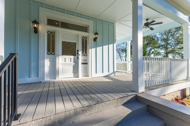 wooden terrace with a porch and ceiling fan