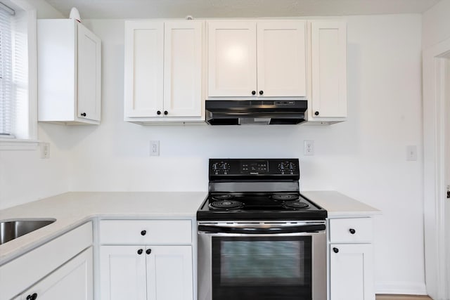 kitchen featuring stainless steel range with electric stovetop, light countertops, under cabinet range hood, and white cabinetry