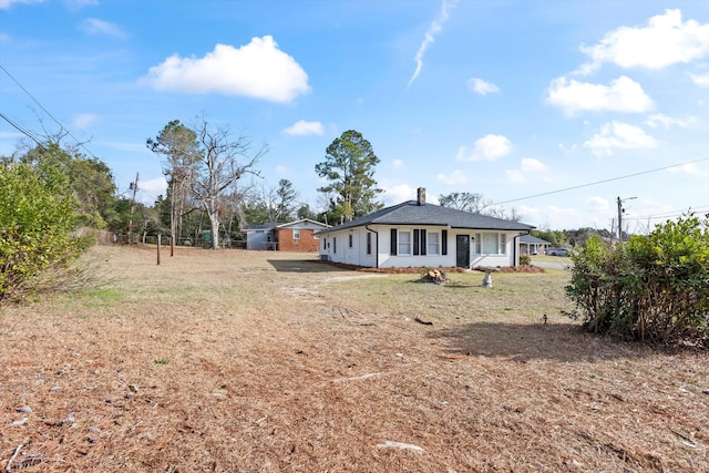 back of property featuring a chimney