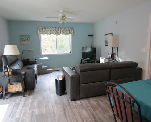 living room featuring ceiling fan and light wood-type flooring