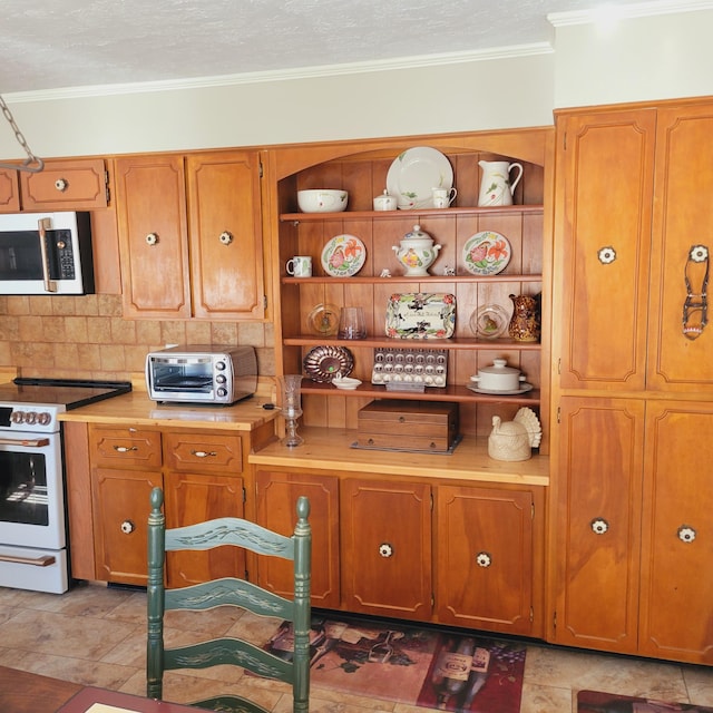 kitchen featuring light countertops, crown molding, a toaster, and white electric range