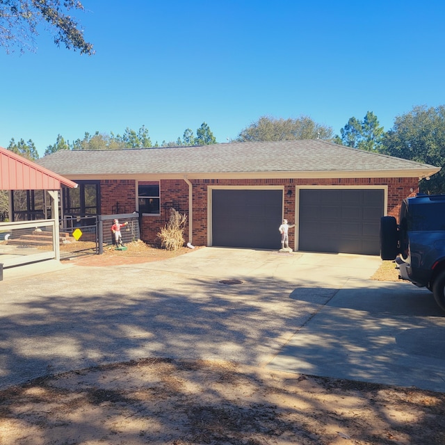 single story home with brick siding, an attached garage, concrete driveway, and a shingled roof