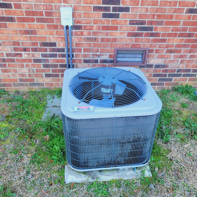 details with central air condition unit and brick siding