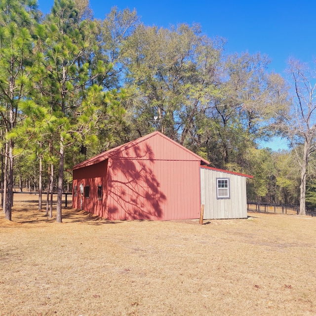 view of outbuilding with an outdoor structure and fence