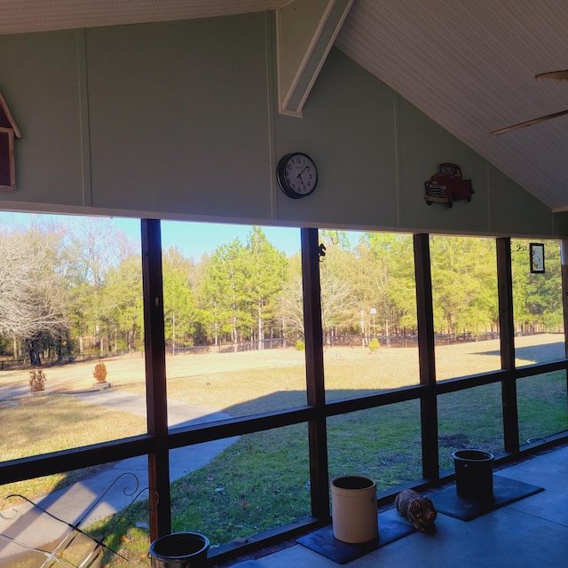 unfurnished sunroom featuring vaulted ceiling