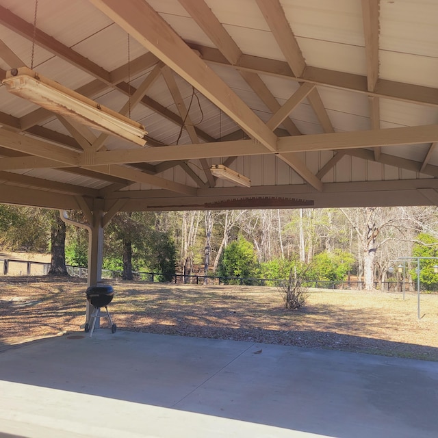 view of patio with fence and a grill