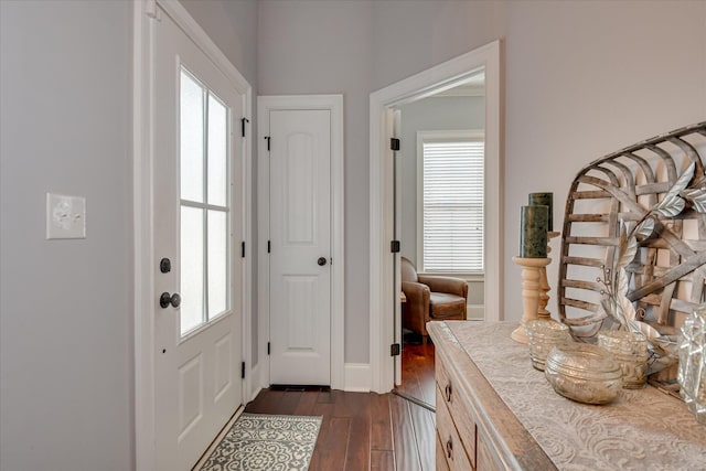 entryway featuring dark wood finished floors, healthy amount of natural light, and baseboards