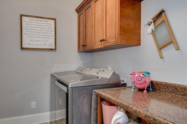 washroom with cabinet space and washing machine and clothes dryer