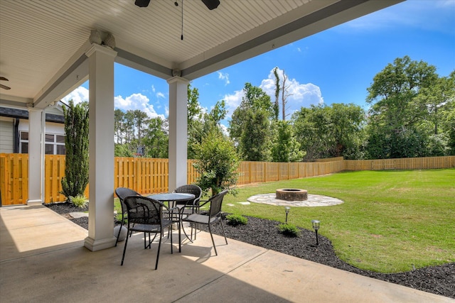 view of patio with a fire pit, a ceiling fan, and outdoor dining area