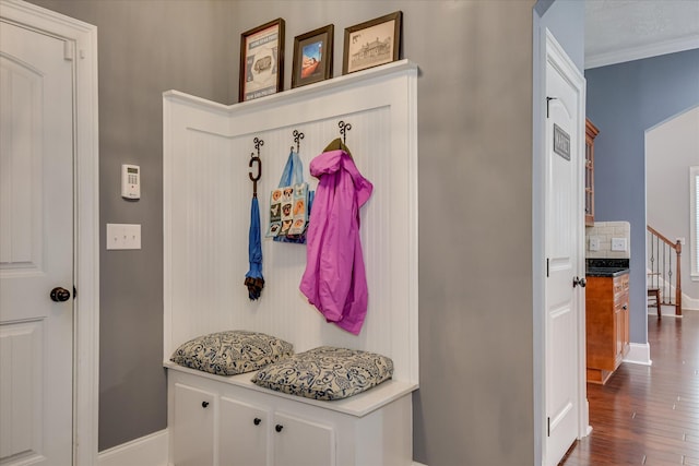 mudroom featuring dark wood finished floors, baseboards, and ornamental molding