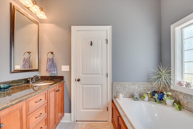 bathroom with vanity and a garden tub