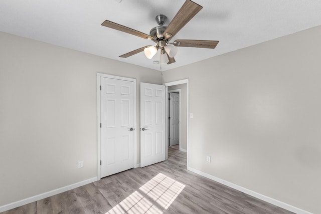 unfurnished bedroom with light hardwood / wood-style floors and ceiling fan